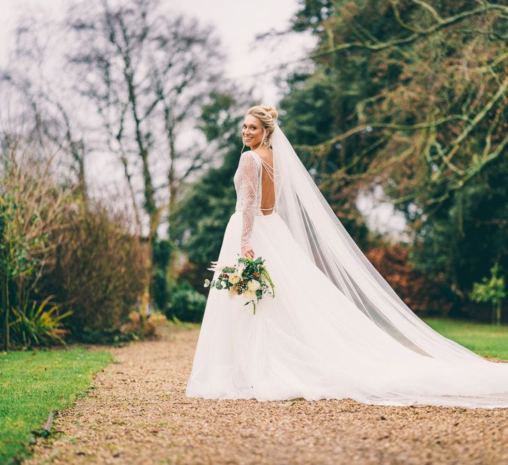 Bride in Enzoani wedding dress with low back detail