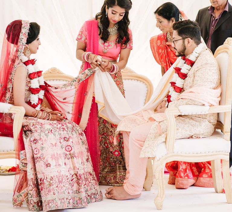 Hindu saptapadi ritual where the bride and grooms veil and cape are tied together