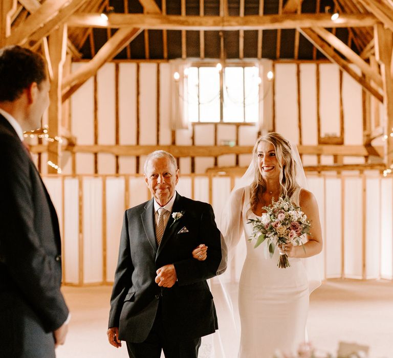 Father of the bride walking his daughter down the aisle at intimate Clock Barn wedding ceremony 