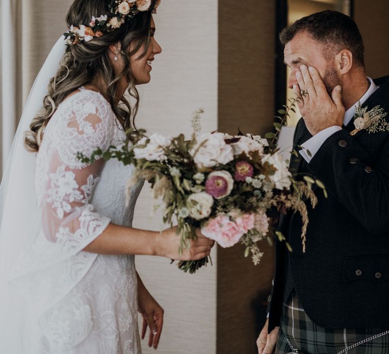 Emotional father in kilt sees Bride carrying rose bouquet for the first time