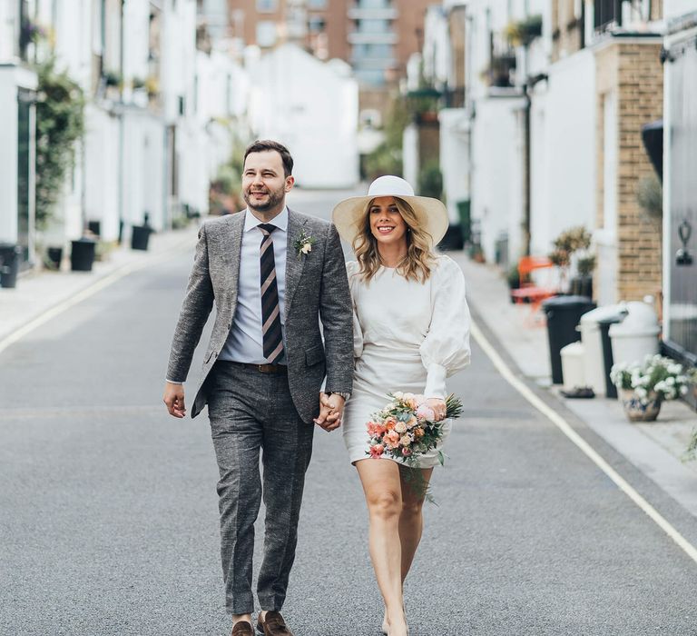 Bride and groom walking on London streets in Marylebone 