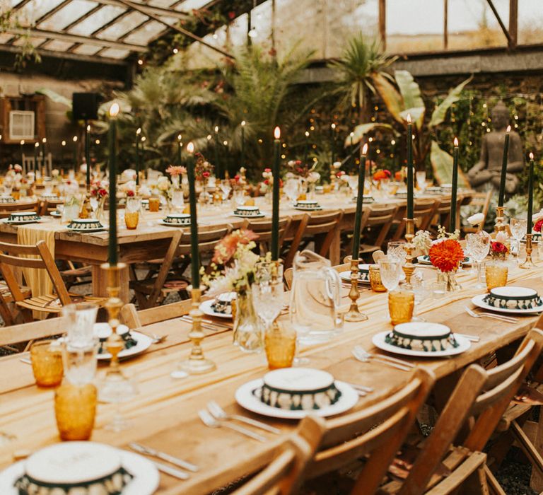 Moroccan, and autumn themed wedding decor at glasshouse wedding reception with coloured glassware, taper candles and tambourine wedding favours 