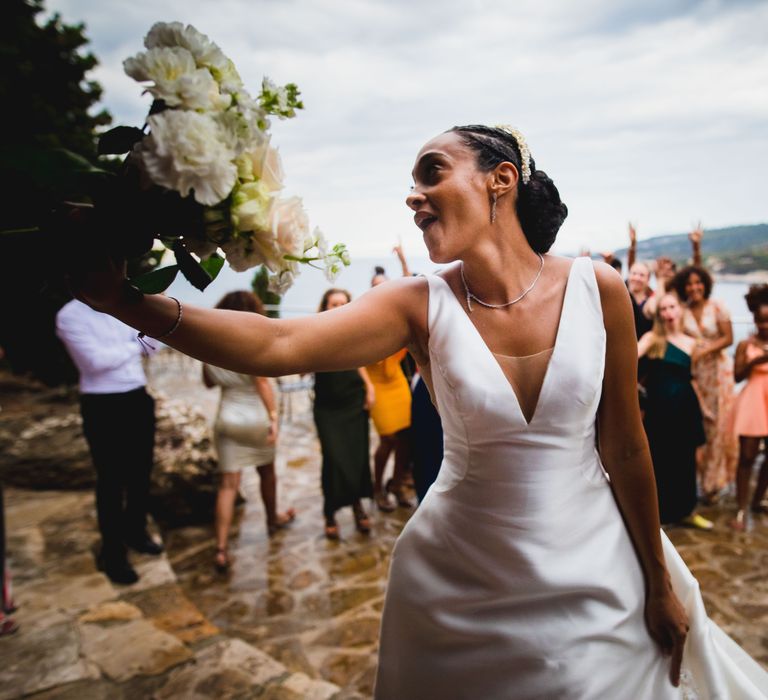 The bride throwing her bouquet into the crowd