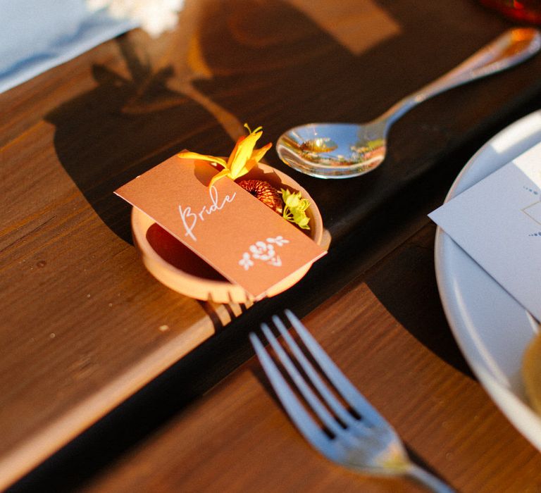 Terracotta plate and name label for a destination wedding in Greece