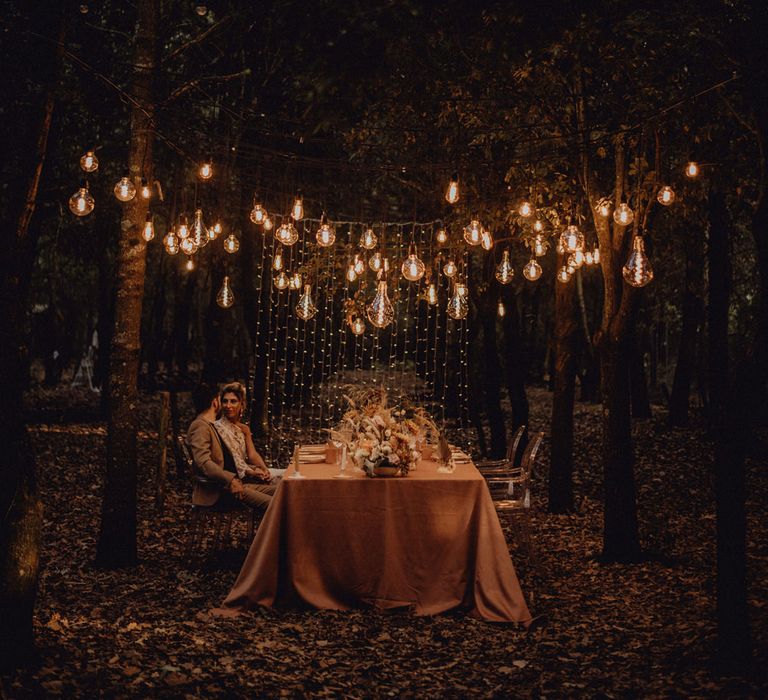 Festoon and fairy light wedding lighting at outdoor forest wedding 