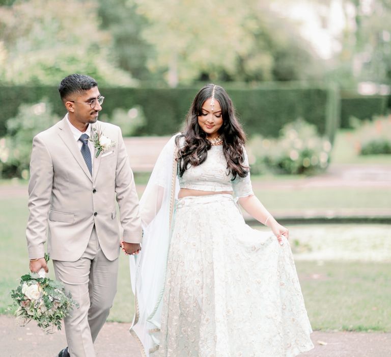 Interfaith wedding with Sikh groom in a beige suit and bride in a mint green sari with long wavy hair 