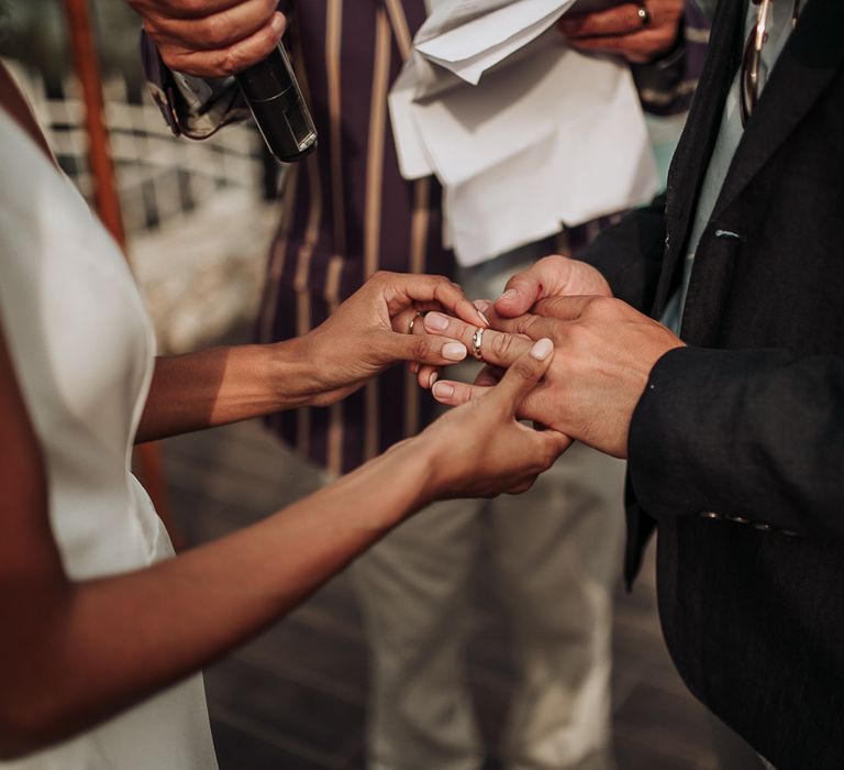 Bride with pale pink nails exchanges rings with new husband at wedding in Croatia