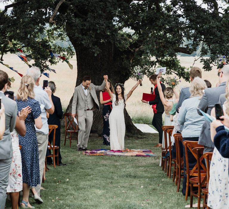 Bride & groom during outdoor wedding with rustic vibe 