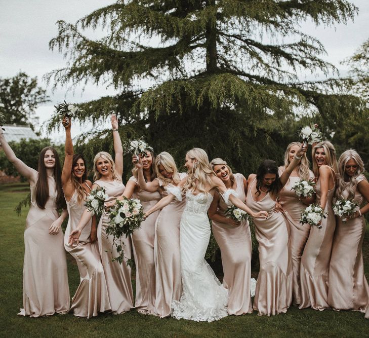 Bridesmaids in champagne gold Ghost bridesmaid dresses at destination wedding 