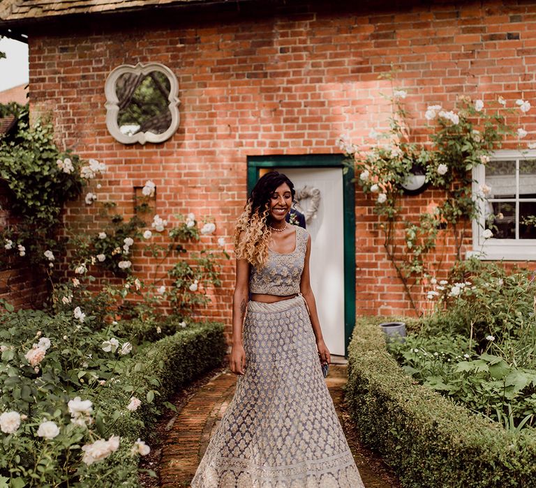 Bride wears traditional lehenga in grey and gold embroidered design | Joshua Gooding Photography