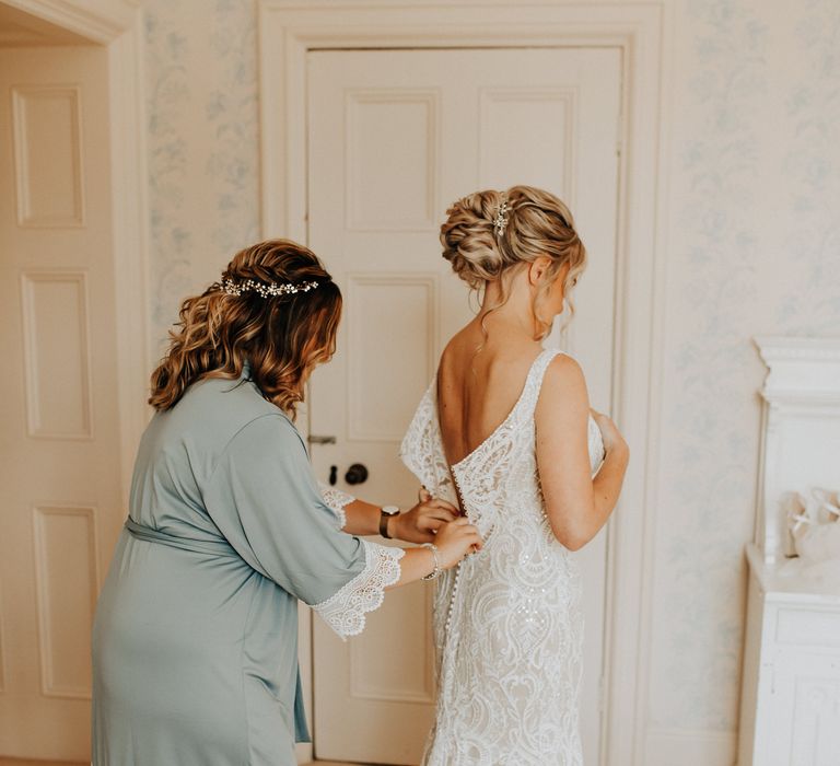 Bride slips into a Maggie Sottero wedding dress