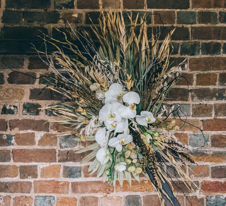 Wooden hexagonal altar with dried flower arrangement 