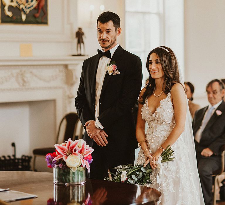 Bride & groom stand together during their wedding ceremony