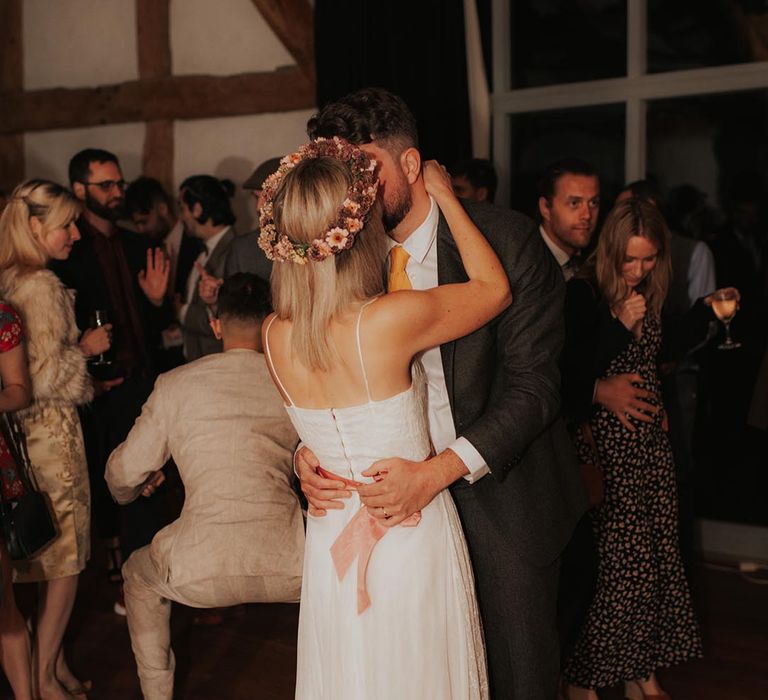 Bride and groom kiss on dancefloor