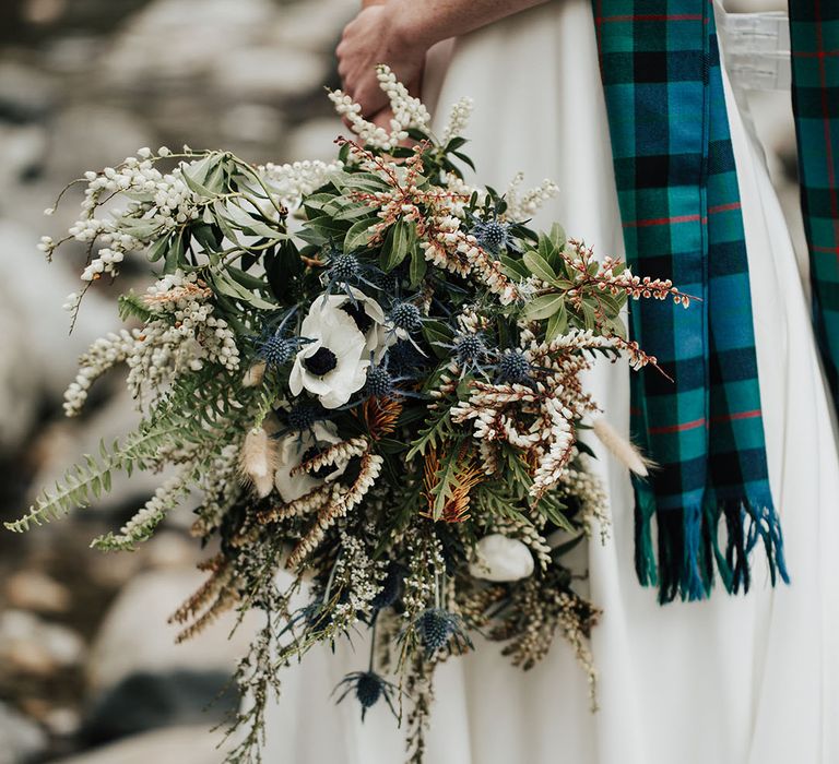 neutral wedding bouquet with anemones, thistles and wildflowers