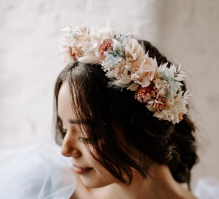 Bride in a pastel peach, pink, beige and blue dry flower hair accessories