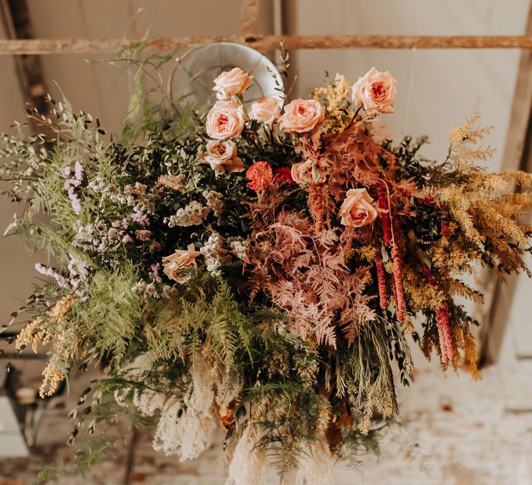 Green, pink and yellow mixed flower cloud with ferns and roses for industrial style wedding at Scale wedding venue in Liverpool