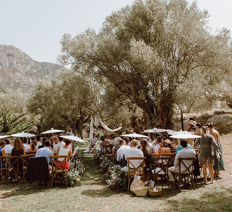 wedding guests and groom await for arrival of the bride at destination wedding