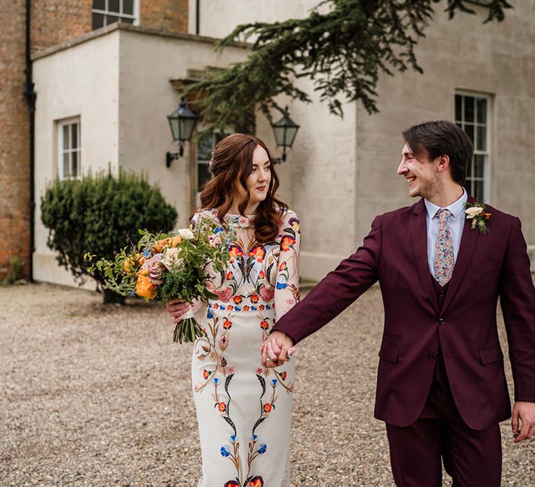 Bride and groom walk together around their wedding venue