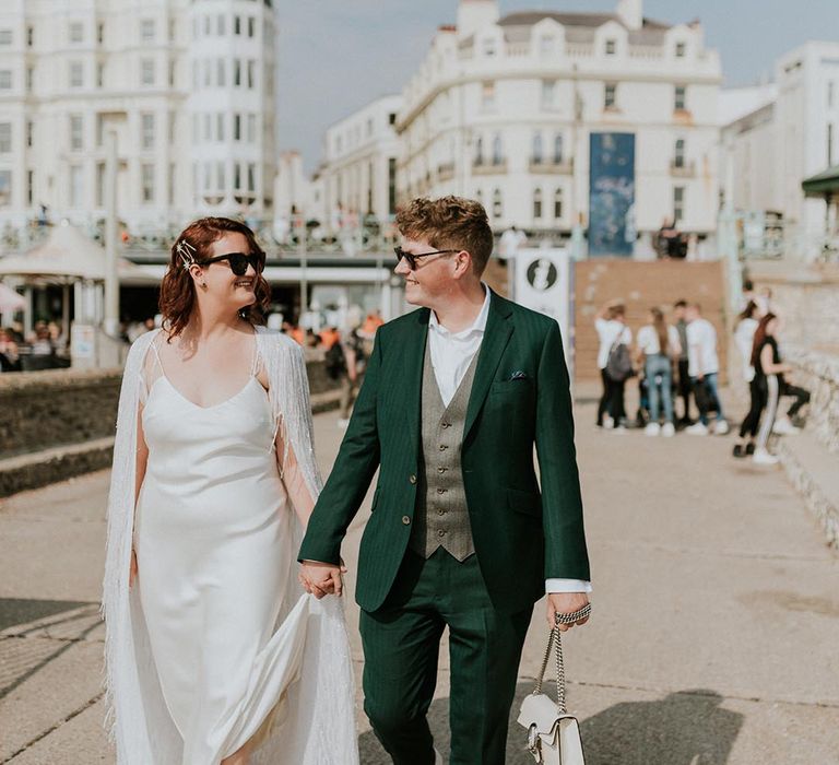 Brighton wedding with bride in a Halfpenny London wedding cape and sunglasses 