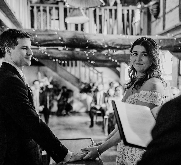 Bride and groom hold hands for their wedding ceremony 