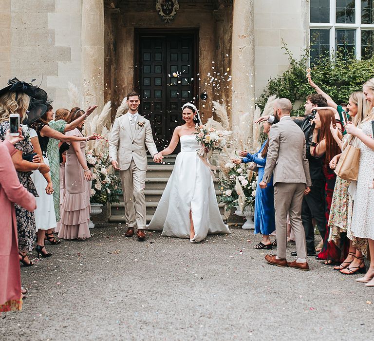 Bride and groom exit from Elmore Court wedding ceremony to confetti 