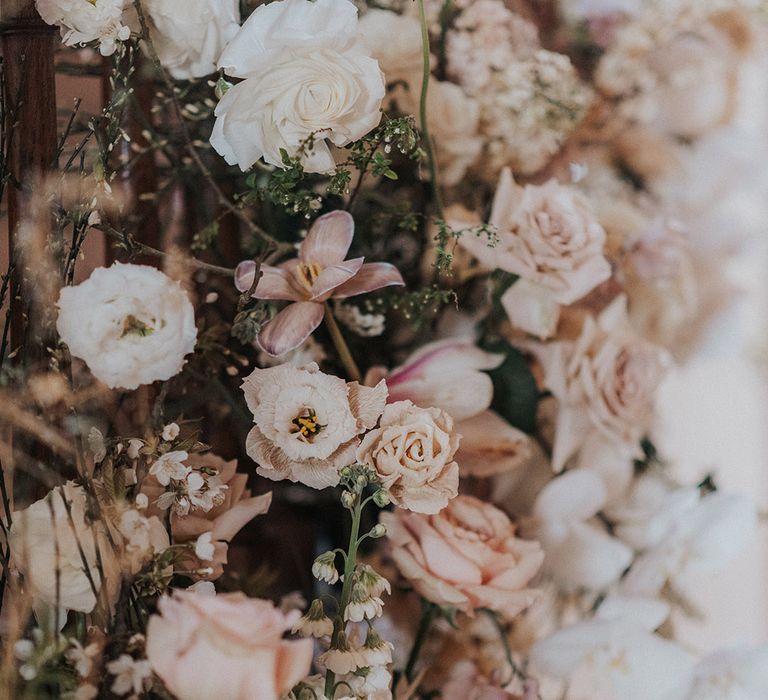 Pink and white wedding flower arrangement on the staircase 