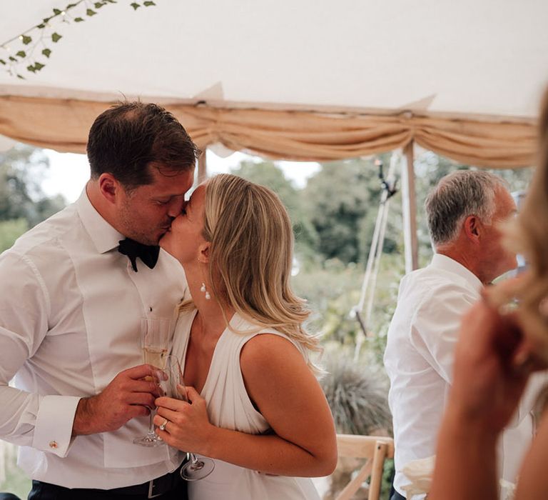 The bride and groom share a kiss and moment together on their wedding day at Pythouse Kitchen Gardens wedding venue 