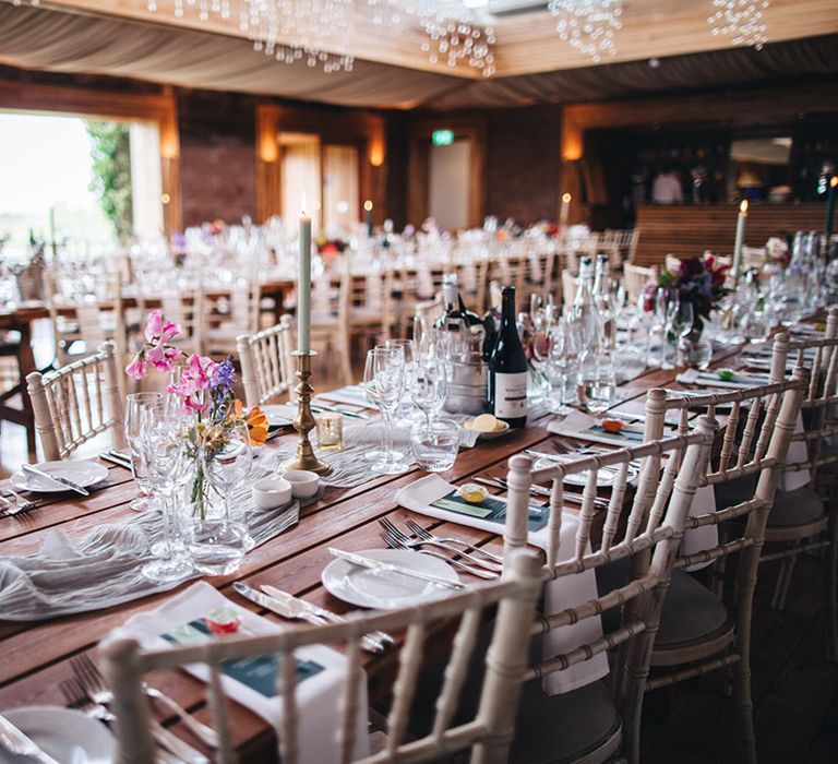 Simple and clean wedding tablescape with pops of green from the menu and wedding stationery and lollipop wedding favours 