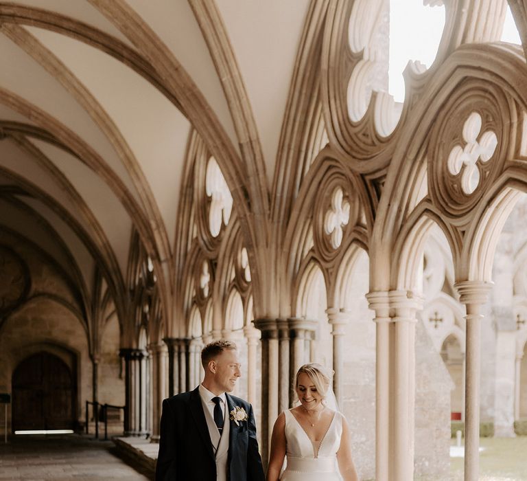 The bride and groom walk around the grounds of their incredible wedding venue 