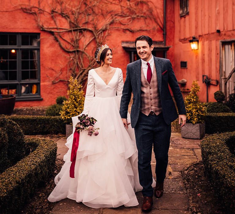 Pauntley Court country house wedding venue with the bride in a Morilee wedding dress and groom in three piece suit 