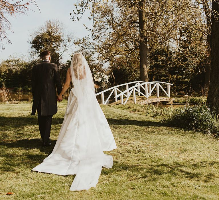 Cute couple wedding photography of the bride and groom walking around their wedding venue 