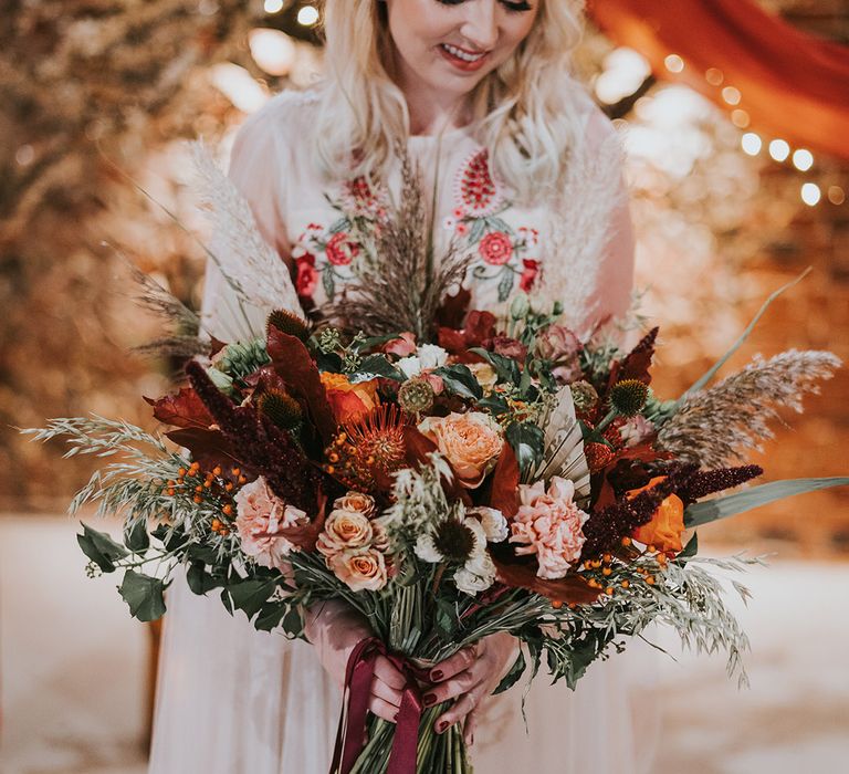 Carnations, roses and dried pampas grass in large oversized autumn wedding bouquet 