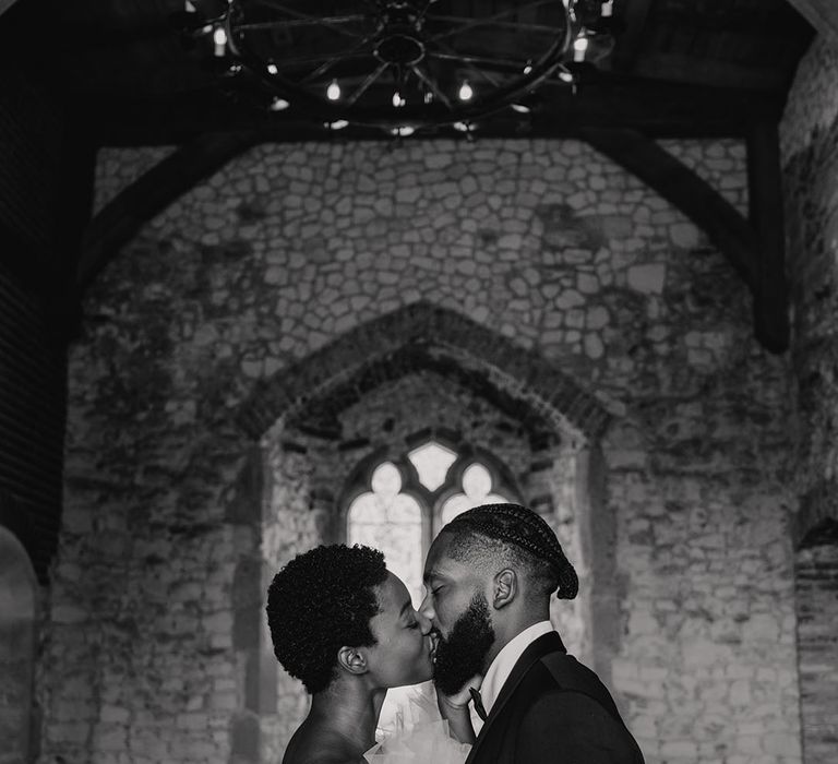 Pentney Abbey historic wedding venue on a medieval site with the groom wearing a black tux and bride in off the shoulder dress 