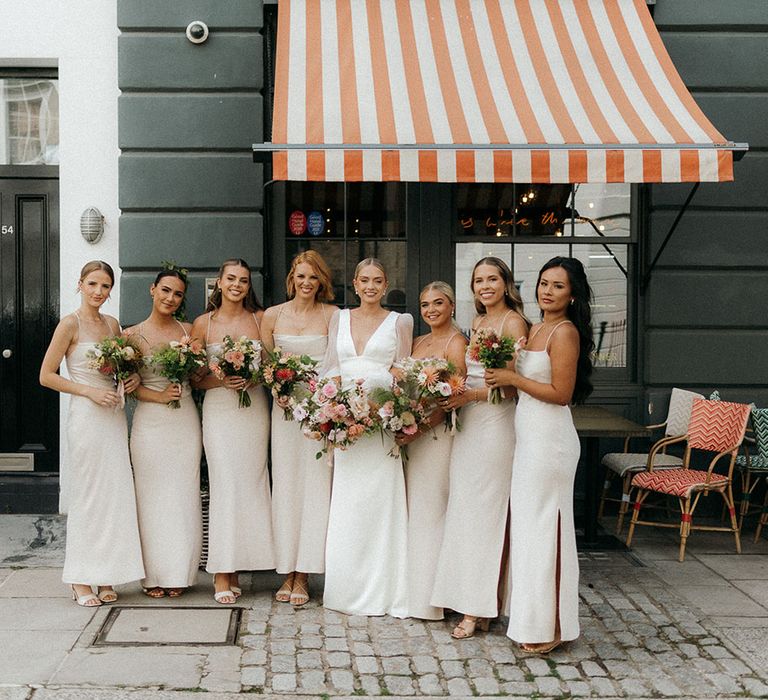 Bridesmaids in neutral tone bridesmaid dresses for retro glam wedding 