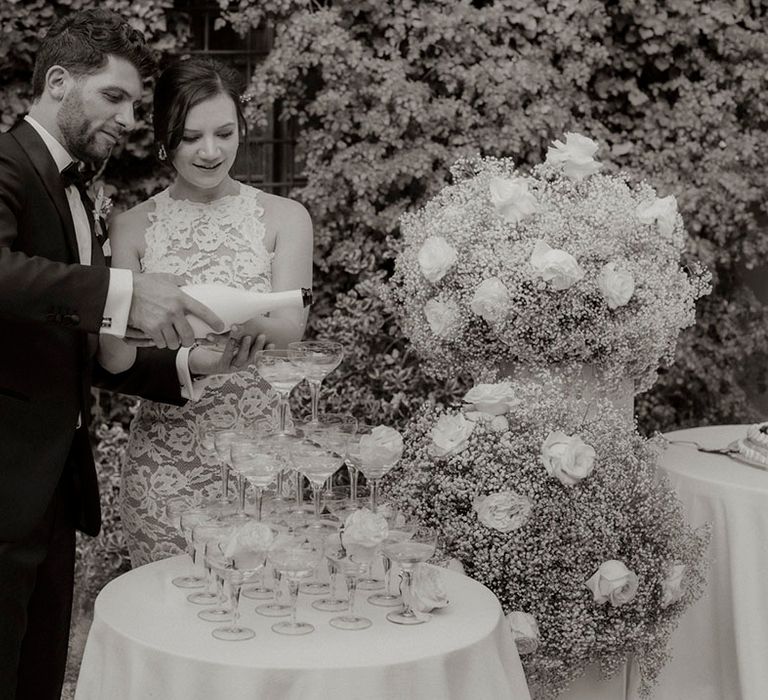 Classic champagne tower wedding decor at intimate dinner party wedding 