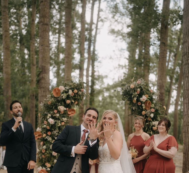 The bride and groom show off their new wedding rings at Tenuta Savoca 