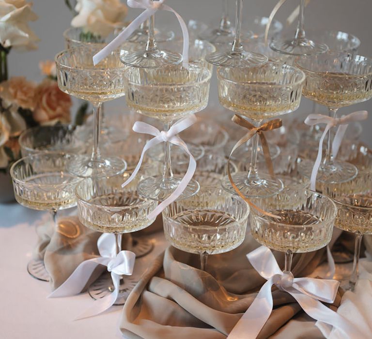 Champagne Tower Wedding Drinks with Pink Bow Decoration