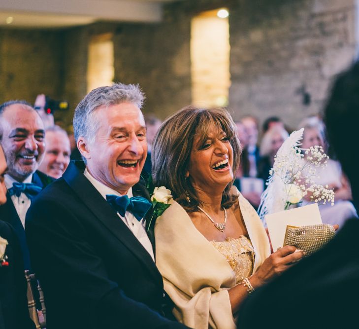 Wedding guests laughing during the wedding ceremony 