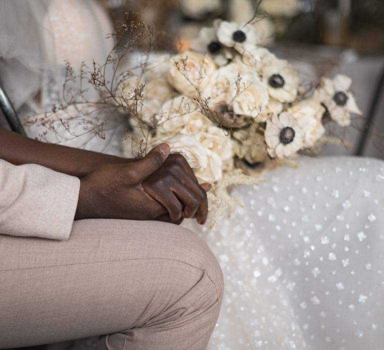 Bride and groom holding hands 