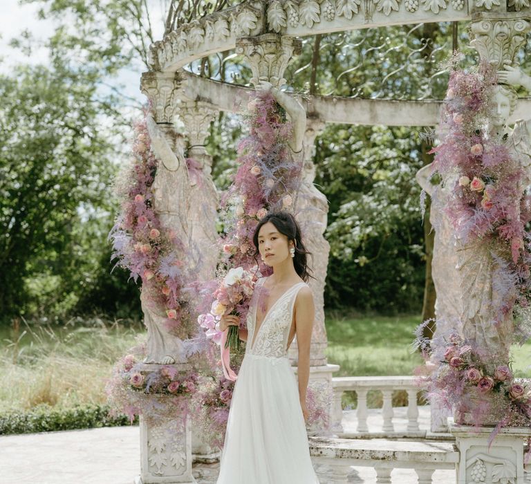 Bride walks away from bandstand wearing a low cut wedding gown