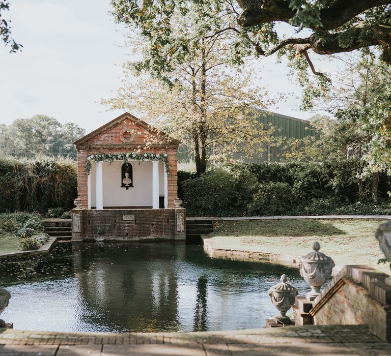 Steps lead to large pond with ceremony venue at the end