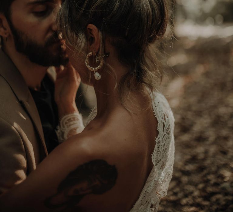 Bride with a topknot and fresh flowers in her hair 