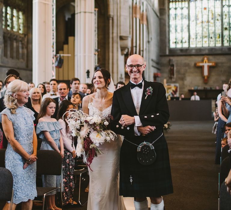 Bride walks down the aisle with her father