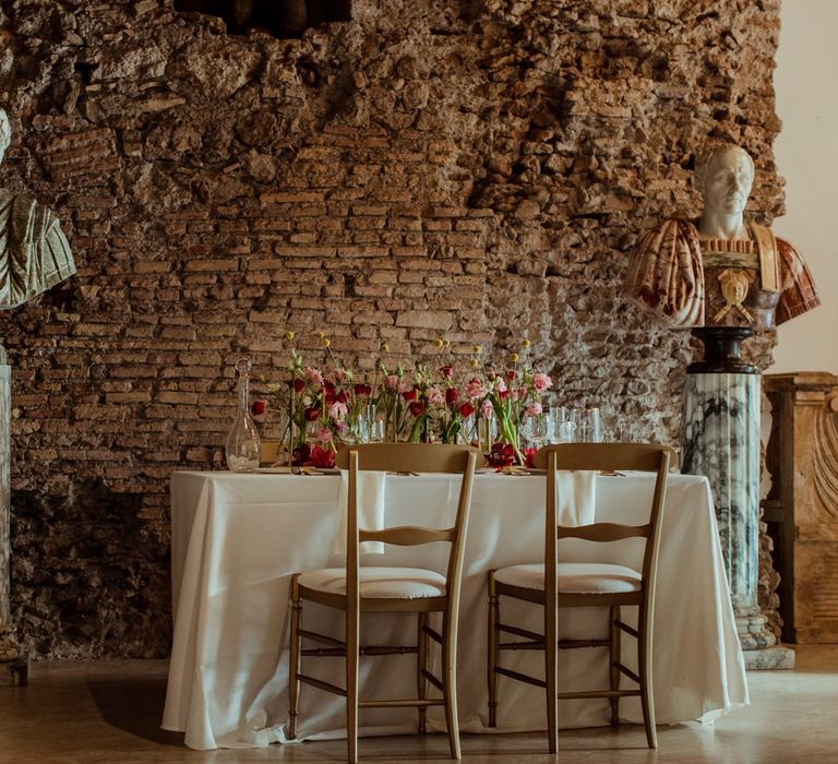 Micro wedding celebration in Rome with pink and red floral centrepieces