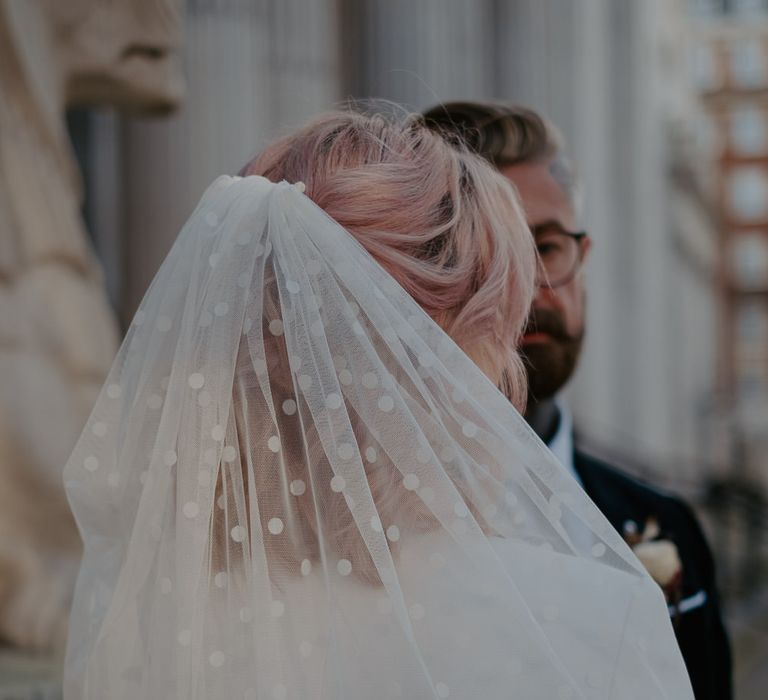 Bride's short white polka dot veil