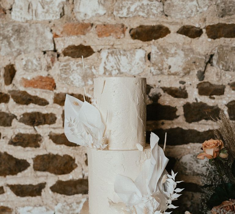 Round and square three-tier buttercream wedding cake with floral design 