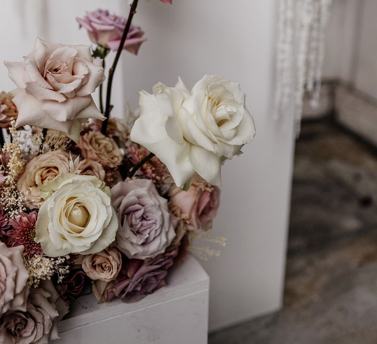 Blush pink, dusky pink and white peeled back rose floral arrangements for luxury outdoor wedding 