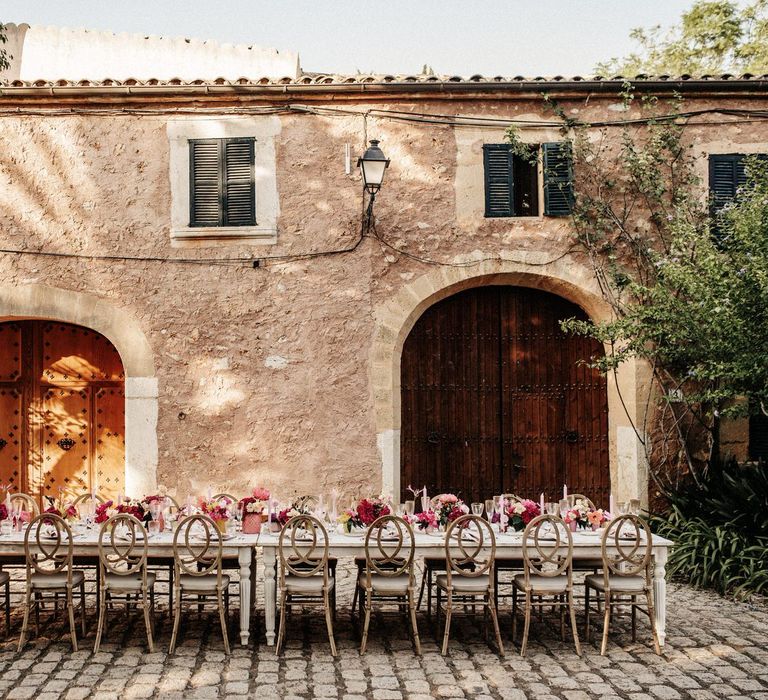 Banquet wedding table with pink flowers at Finca Biniagual