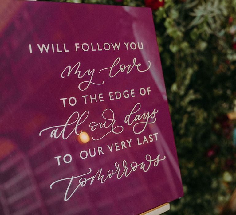 Burgundy quote wedding sign with gold font. "I will follow you my love to the edge of all our days to our very last tomorrows"